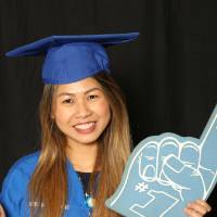 nursing student holds up foam finger with thumbs up for a picture